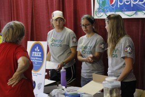 Elyse (center) with two other EC members (Caroline, left) (Amy, right) last year handing out weatherization materials