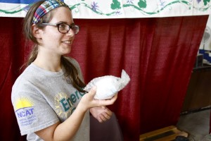 Elyse handing out an efficient shower head